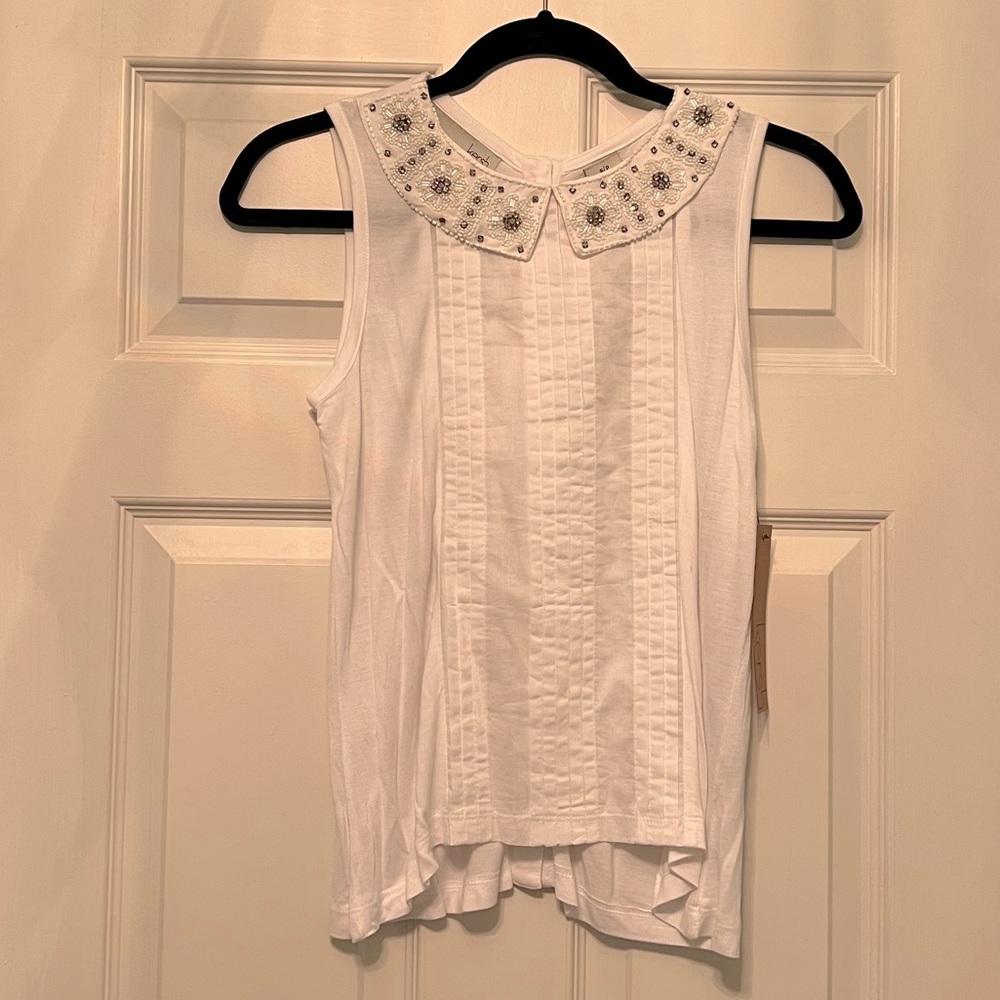 White top with rhinestone accents on collar